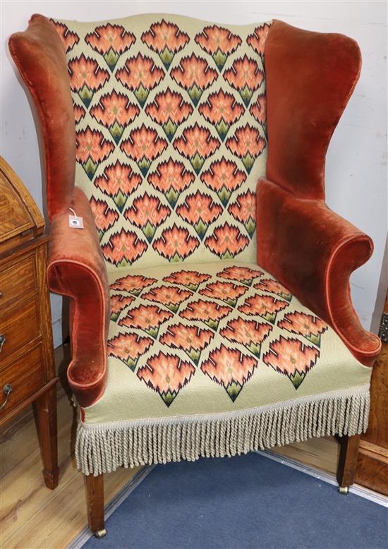 A George III mahogany wingback armchair